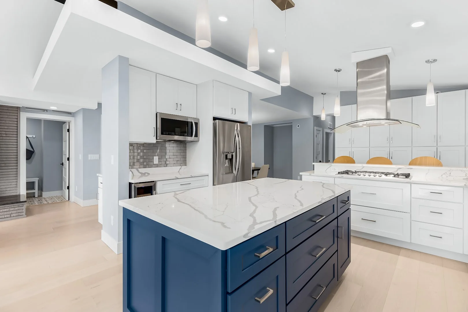 Blue and white semi-custom kitchen with a broad island